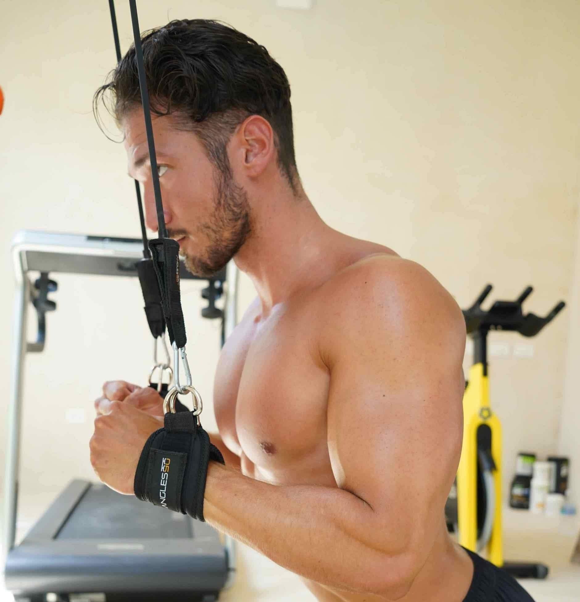 A focused man engaging in a workout at the gym using the A90 Leg Day Set, demonstrating a moment of intense concentration and physical exertion.